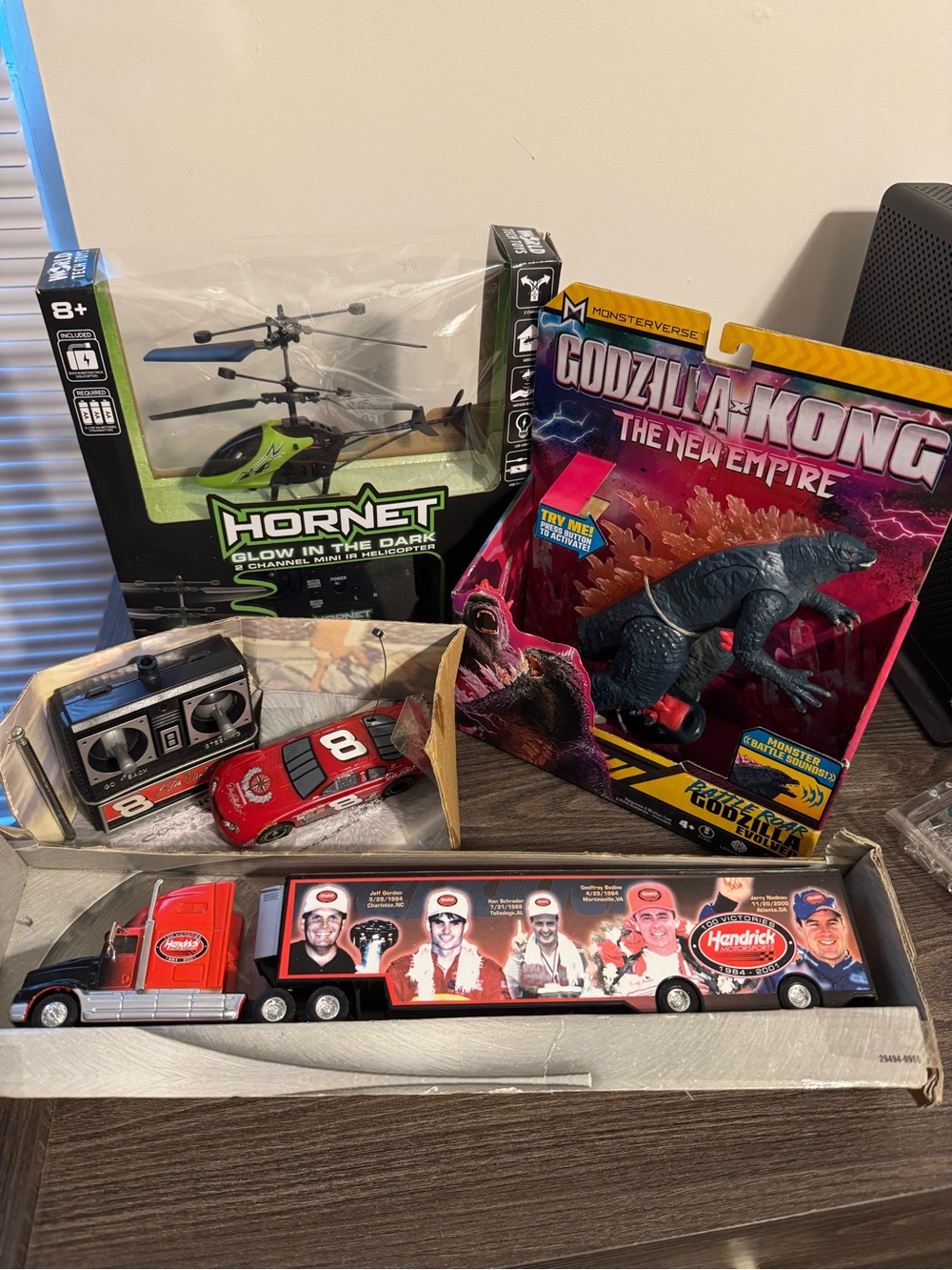 Child Toy Lot featuring a truck, race car helicopter and Godzilla